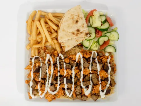 Ahsan's Halal chicken and lamb mix over rice with fries, pita, and salad