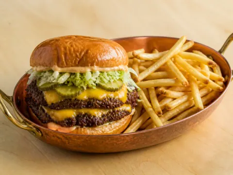 Representative a halal double smashburger with melted cheddar, pickles, shredded lettuce, house sauce, and thin crispy fries selected for CHAR'D (Tysons Galleria)